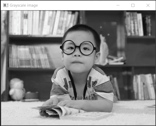 Boy with spectacles in grayscale
